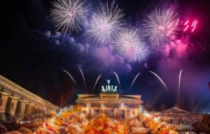 Vibrant Diwali 2025 celebration along the Spree River in Berlin, Germany, featuring over 5,000 attendees, earthen diyas and LED lights, Bollywood dancers, rangoli workshops, and a riverside mela with samosas and fusion currywurst chaat, set against autumnal skies on October 20 2025