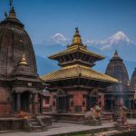 A serene, detailed, and high-quality image showcasing the famous Shiva temples of Nepal, such as the pagoda-style Pashupatinath Temple on the banks of the Bagmati River and the natural cave shrine of Halesi Mahadev. The temples are depicted surrounded by lush green mountains and sacred rivers, without any human figures, evoking a peaceful and spiritual atmosphere suitable for the holy month of Karthika Masam.