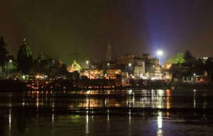 Family performing Lakshmi Puja at home in Bhubaneswar on Diwali 2025, featuring rangoli, diyas, and offerings of sweets and coins.
