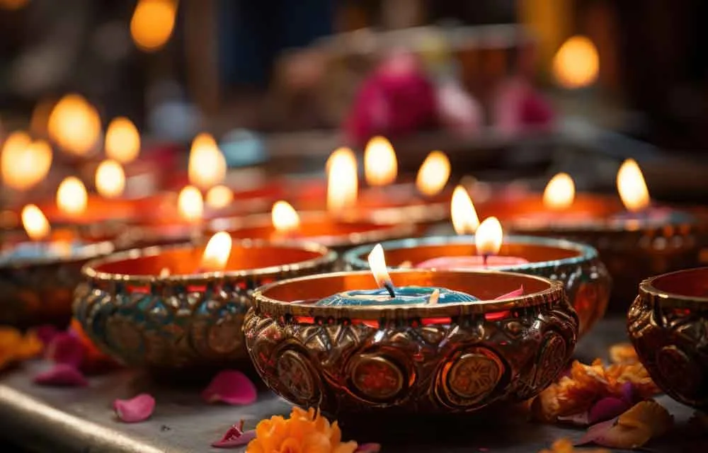 Close-up of decorated clay diyas burning on Diwali