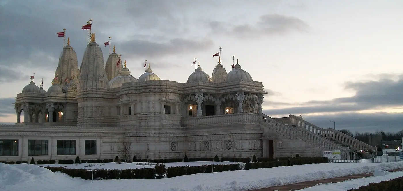 BAPS Shri Swaminarayan Mandir in Toronto, a white marble temple with domes and spires, in winter snow