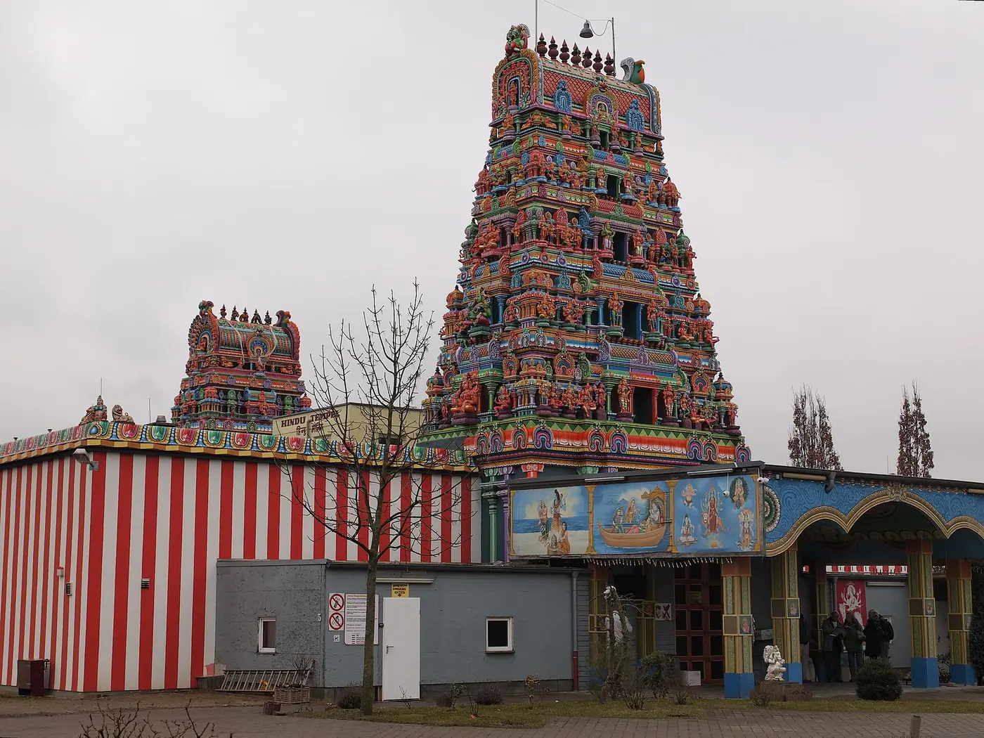 Colourful gopuram and red-and-white striped outer wall at the entrance of the Sri Kamadchi Ampal Temple in Hamm-Uentrop